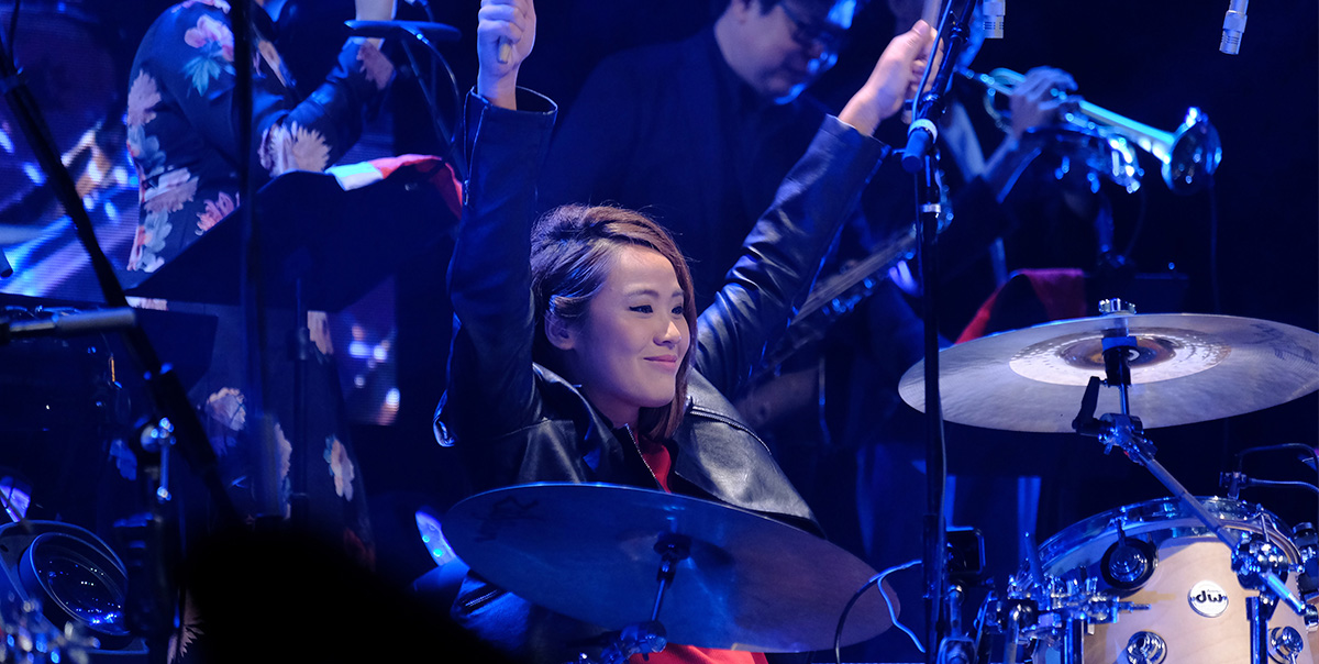 Drummer raising her hands